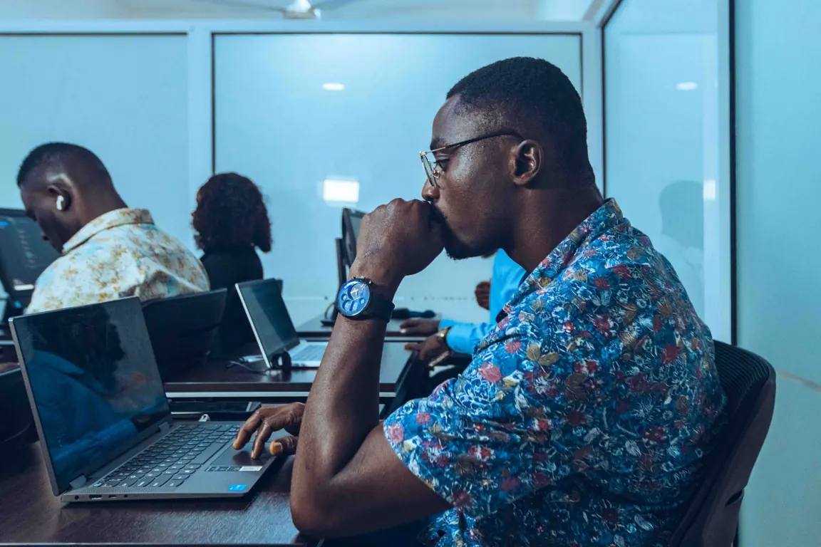 A developer working at a laptop during a technology workshop.